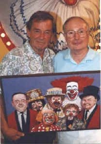 Don with Roy Brown holding a painting of the cast by WGN's Bob Hedberg